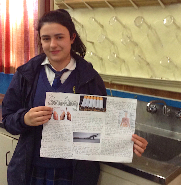 Emma Stewart displays her course work on the impact of smoking.
