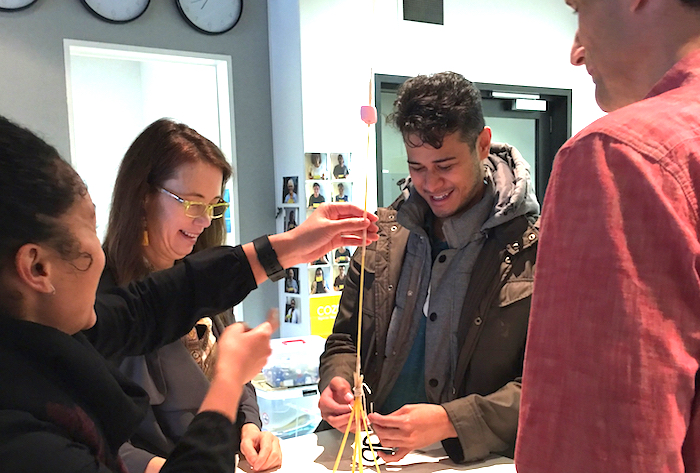 John Oetzel (far right), with researchers and community members, work on a prototype.