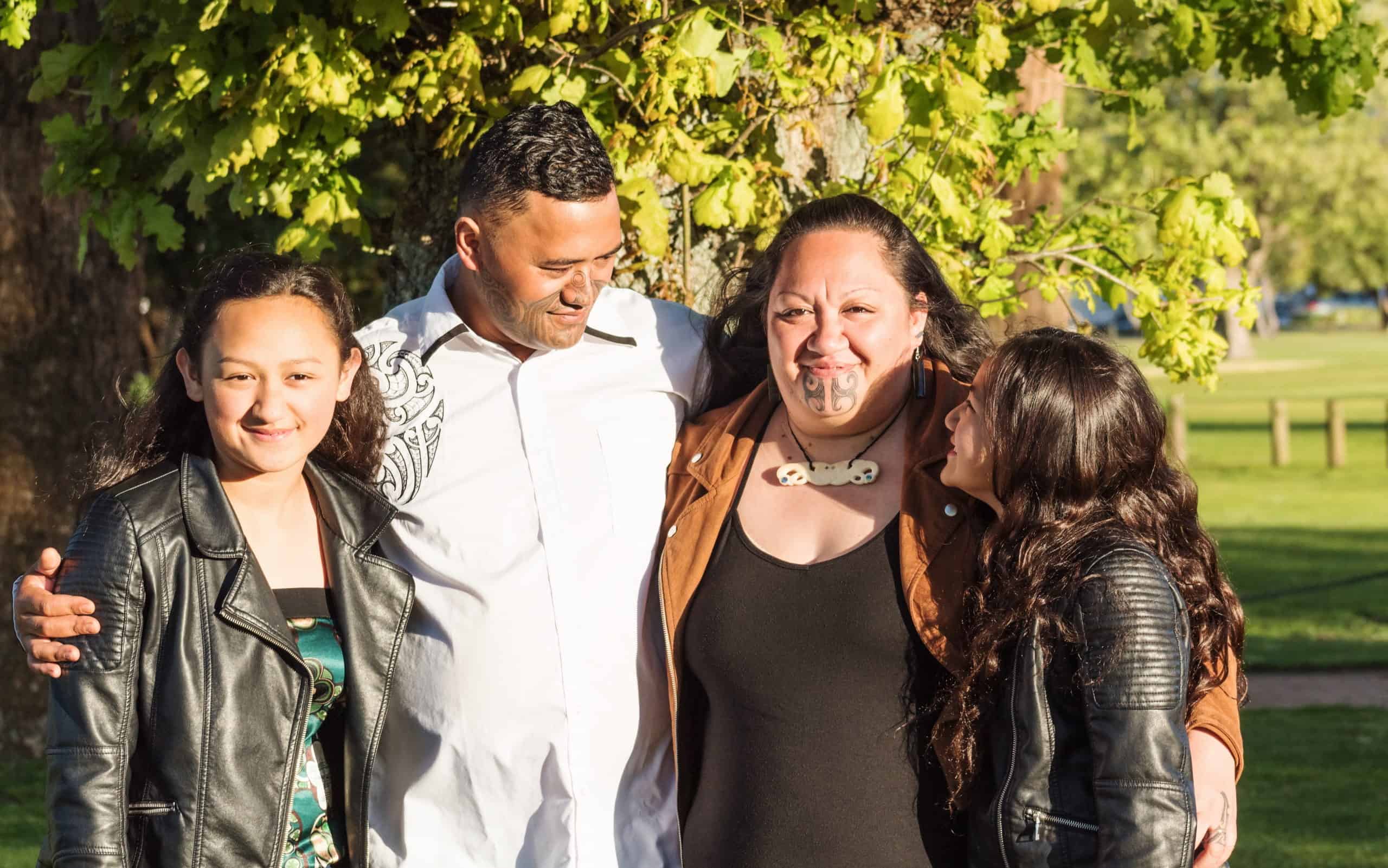 Portrait Of A Young Maori Family Taken Outdoors In A Park Setting