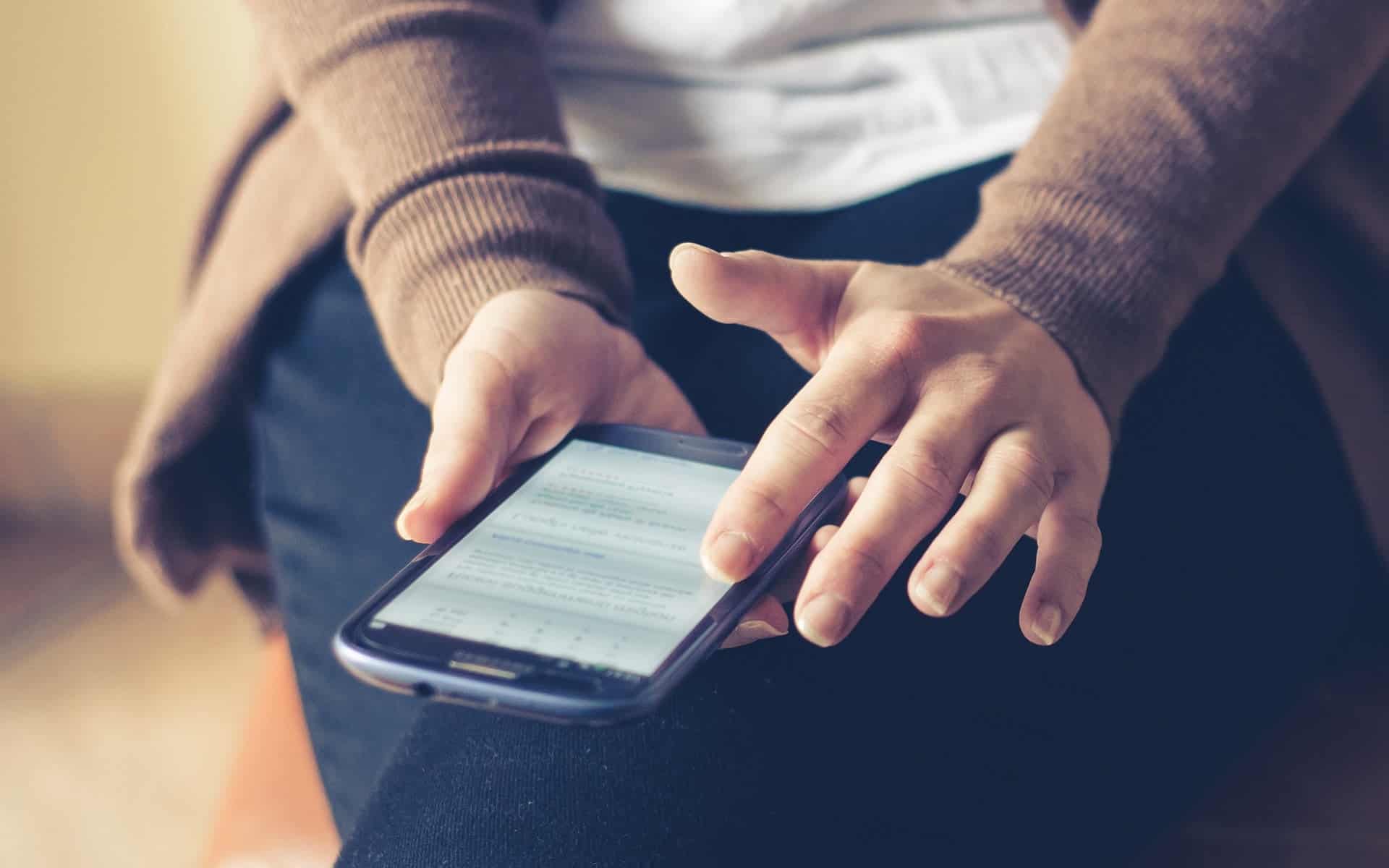 Adult hands holding smart phone